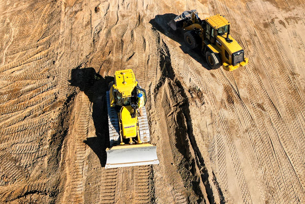 Bulldozer and front loader performing sitework photographed by drone Kent County RI