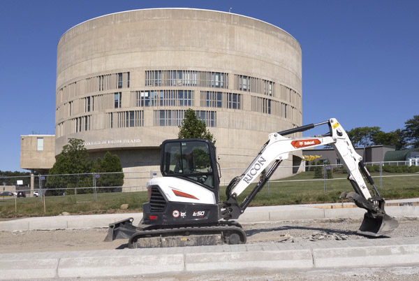 Small excavator prepping bus lane at CCRI from drone point of view Warwick RI