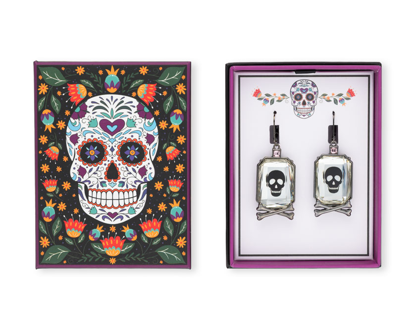 Skull earrings photographed with their packaging on white background