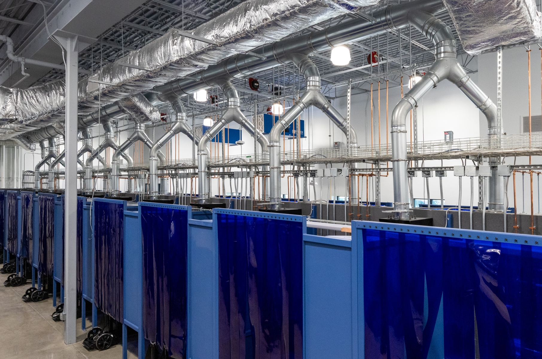 Overhead view of piping and ductwork Lincoln Tech welding facility