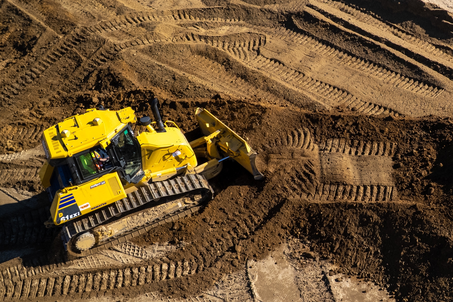 Bull dozer moving dirt at worksite