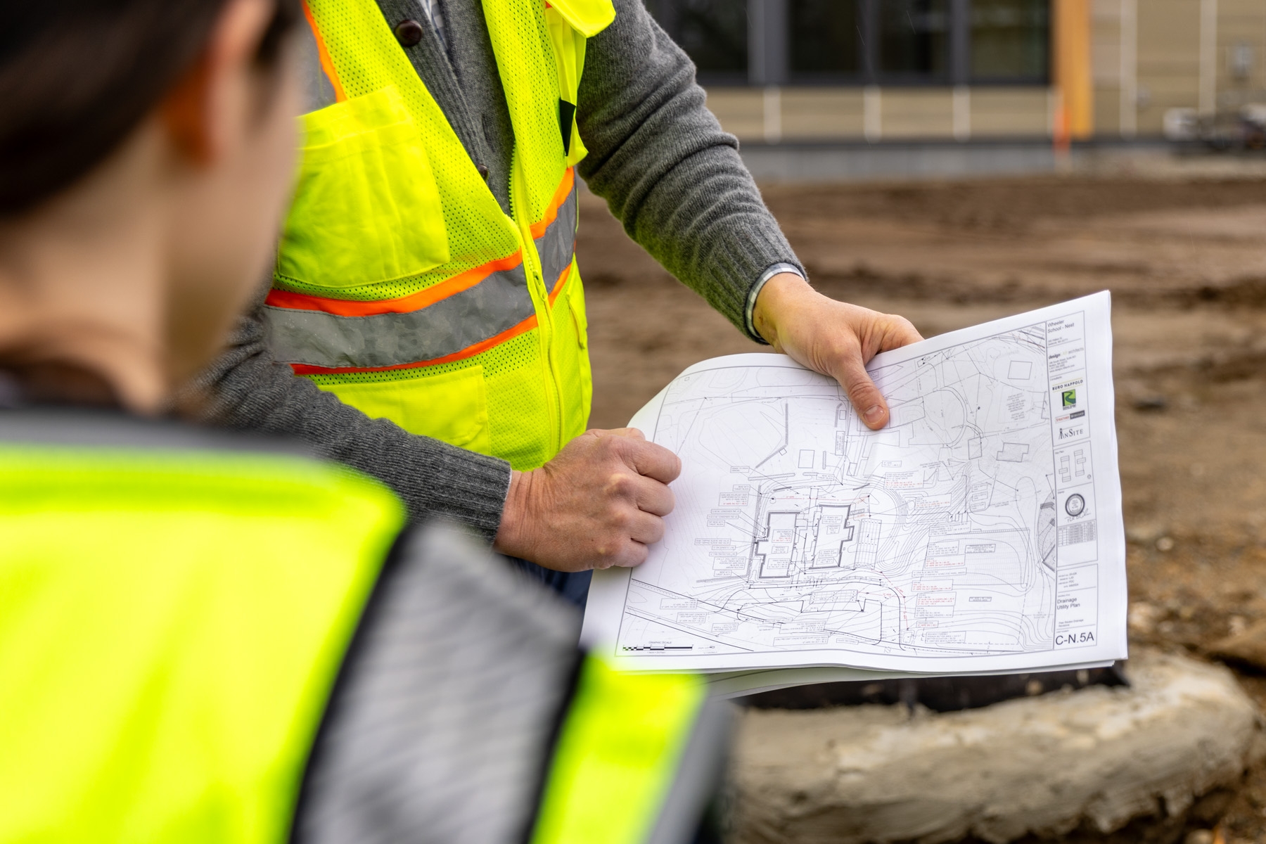 Engineers walking through construction site with plans