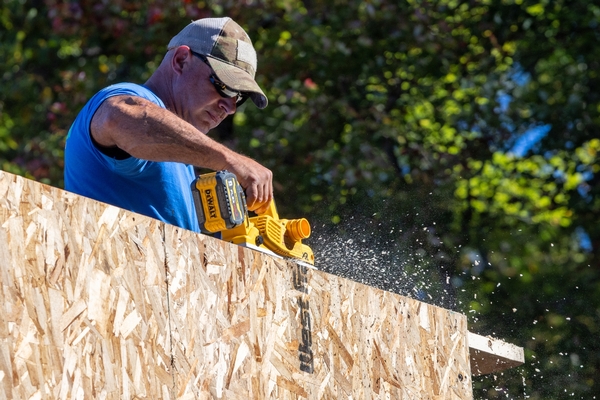Construction team member planing top plate for fitment
